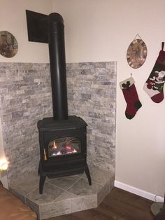 a fireplace in a living room with stockings hanging on the wall