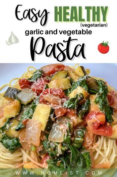 pasta with spinach, tomatoes and other vegetables in a white bowl