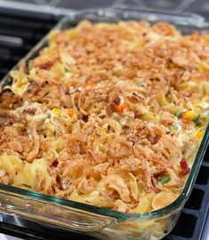 a casserole dish with noodles and other toppings in a glass baking dish