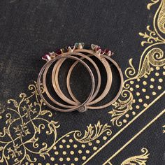 Harem rings come to us from the Victorian era, with a few different theories as to how they came into existence. They are made from 5 smaller bands. All mechanically joined together to create one wider band, often dotted with baby gemstones for a “confetti” appearance. Ours is in vintage rose gold, with the juiciest and brightest little gemstones! This ring is perfect for one who loves to fidget and play with their jewelry - the bands all individually hinge and move around in the most fun way. 1 Heirloom Style Stackable Emerald Ring, Heirloom Multi-stone Round Band Rings, Harem Rings, Modern Mens Rings, Art Jewelry Earrings, The Victorian Era, Vintage Rose Gold, Bespoke Rings, All Band