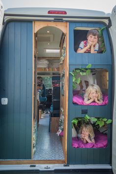 two children are sitting in the back of a van