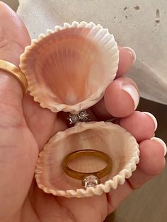 Proposal seashell ring box made from a gorgeous Florida Gulf Coast seashells are stunning!    These gorgeous handmade seashell ring holders are perfect for beach proposals.  They are embellished with silver or gold rhinestones that serve as a hinge and are finished with staggered half pearls for added delight. They have minimal bling in order to be the perfect surprise proposal ring holder.  It will include a clear cord to keep the seashell closed. Simply place ring inside, close and place clear Ocean-inspired Shell-shaped Rings As Gift, Elegant Shell-shaped Ring For Gifts, Ocean-inspired Shell Jewelry For Wedding, Ocean-inspired Shell Wedding Jewelry, Shell-shaped Shell Jewelry For Wedding, Elegant Round Shell As Gift, Elegant Shell Gift, Elegant Round Shell Gift, White Shell For Wedding