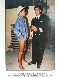 two men standing next to each other in front of a wall wearing sailor's uniforms