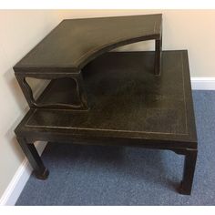 a wooden table with a curved shelf on top