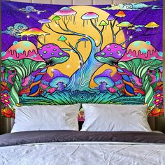 a bed with a colorful wall hanging over it