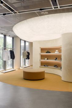 the inside of a clothing store with shoes on display