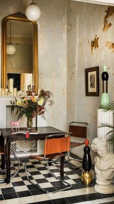 a table and chairs in a room with a checkered floor