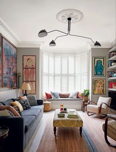 a living room filled with furniture and lots of windows