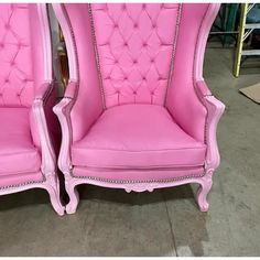 two pink chairs sitting next to each other