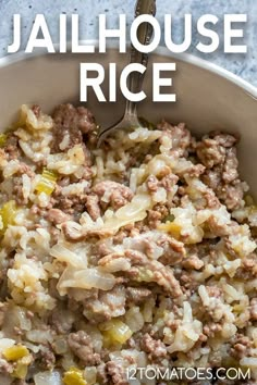 a bowl filled with rice and meat on top of a blue tablecloth next to a spoon