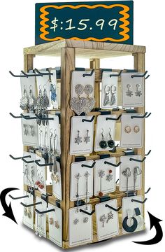 a display case with earrings and earring hooks on it's sides for sale