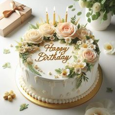 a birthday cake decorated with flowers and candles