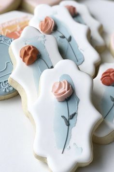 decorated cookies with frosting and flowers on them