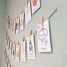 some cards are hanging on a clothes line with clothes pins and magnets attached to them