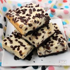 chocolate chip cheesecake bars stacked on top of each other with the title above it