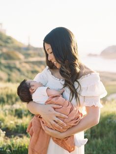 a woman holding a baby in her arms