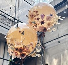 two balloons with flowers and butterflies on them