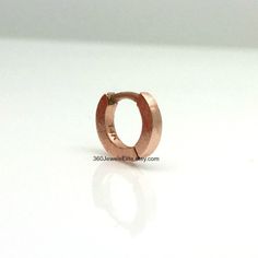 Handmade from solid 14K rose gold. This tiny hoop earring measures approximately 5mm inner diameter. Great for helix, tragus, anti tragus, daith, eyebrow, or rook piercings. Sold as a single hoop cartilage earring. Product attributes Metal: high quality 14K solid rose gold Inner diameter: 5mm Width: 1.4mm Ear post: 20G. Can be customized to other gauges. 14K white gold polished https://www.etsy.com/listing/127764306 14K white gold matte https://www.etsy.com/listing/179694245 Thank you for your i Tragus Daith, Anti Tragus, Earring Cartilage, Raspberry Smoothie, Tiny Hoop Earrings, Cartilage Earrings Hoop, Cartilage Earring, Gold Polish, Cartilage Earrings