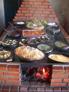 an outdoor pizza oven filled with lots of food