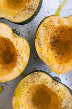 four squash halves with seasoning on them