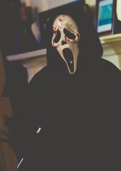 a person wearing a mask with the words what's your favorite scary movie?