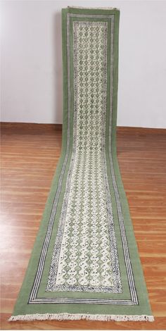 a green and white rug on the floor