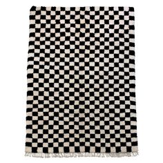 a black and white checkered rug with fringes