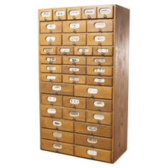 an old wooden filing cabinet with many drawers