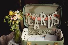 an open suitcase filled with cards and flowers