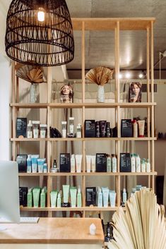 the shelves are filled with different types of cosmetics and personal care products in front of a computer