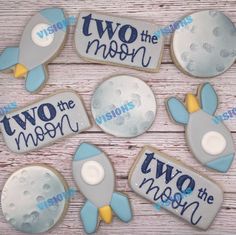 four decorated cookies that say two the moon and two the mars