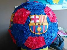 a soccer ball covered in blue and red tissue paper