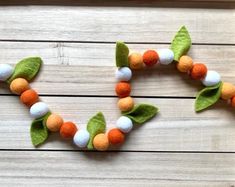 the letter c made out of felt balls and leaves