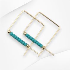 Elevate your style with True - Square Gold & Turquoise! These stunning square threader earrings feature 14k Gold Filled wire and vibrant teal turquoise seed beads, perfect for adding a touch of elegance to any outfit. Embrace your bold and sophisticated side with these unique and eye-catching earrings. 14k Gold Filled Wire Sides of square measure 3/4" Teal Turquoise Miyuki Seed Beads Polished to a High Shine Sent in a Ribboned Gift Box with Polishing Cloth Handmade in Montana Adjustable Square Turquoise Jewelry, African Turquoise, Teal Turquoise, Threader Earrings, Jewelry Packaging, Christmas Shopping, Montana, Seed Beads, Gold Filled