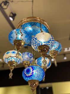 a chandelier with blue and white glass balls hanging from it's ceiling