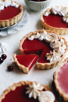 several pies with different toppings on a table