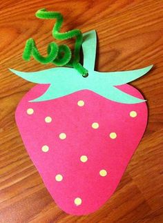 a paper strawberry cut out to look like the letter s is for strawberries on a wooden table