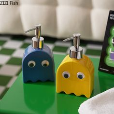 two soap dispensers sitting on top of a green counter