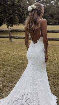 a woman in a white wedding dress looking back