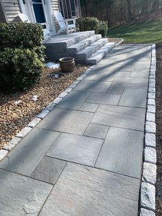 a stone walkway in front of a house