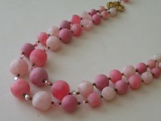 "Very good condition. Probably unmarked Coro. Pink satin or matte plastic, pink ab crystals, metal beads. Shortest strand - 18\" with hook and extender. 19.5\" longest strand. Beads diameter - 10, 12, 15, 20 mm." Pink Double Strand Beaded Necklace With Faceted Beads, Pink Double Strand Faceted Beaded Necklaces, Pink Double Strand Faceted Bead Necklace, Pink Plastic Round Beads Jewelry, Vintage Pink Faceted Beaded Necklaces, Pink Hand-strung Round Beads Necklace, Vintage Pink Faceted Bead Necklaces, Pink Aurora Borealis, Adjustable Hand-strung Pink Necklace