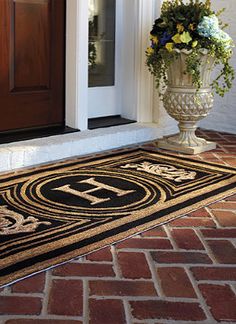 a door mat with the letters h and f on it in front of a house