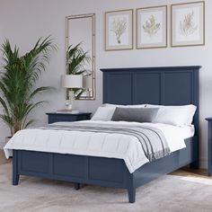 a bedroom with a bed, night stand and two nightstands in blue wood finish