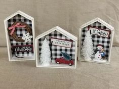 three small houses with christmas decorations on them