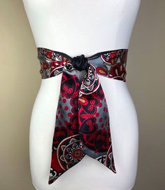 "Medallion Print Sash  in Red, Black & Gray  Bohemian Sash Belt  Black & Red Print Satin Sash Belt  Boho Accessories  Satin Swank  Instantly elevate your jeans, dress, or top with this Satin Swank® reversible waist sash. Depending on your waist size and the length you choose (60, 75, and 90 inch lengths available), you can wrap this sash around your waist once or twice. You decide whether to tie the sash in a bow or a simple knot with long-hanging tails. Tie in front, in back, or on the side. A double layer of silky charmeuse satin in a red/black/gray medallion print on one side and solid black satin on the reverse side. Sash is constructed (hand cut & sewn by Satin Swank®) in one long piece. Ends are finished on the angle and seams are hidden within the fold lines. SIZING/COLOR/PRINT INFO Red Bohemian Silk Scarf For Beach, Bohemian Red Silk Scarf For Beach, Bohemian Sash, Medallion Print, Waist Sash, Satin Sash, Sash Belts, Boho Accessories, Sash Belt