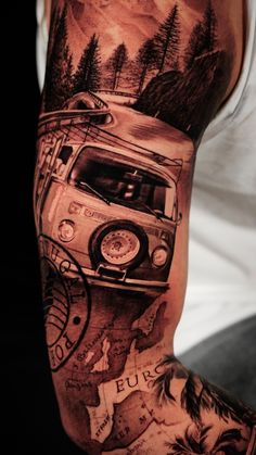 a man's arm with a car and mountains on it