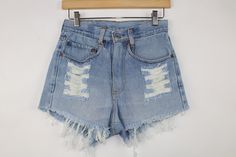 One-of-a-kind pair of up-cycled vintage Levi's shorts. Features a high waisted cut and tattered edges.  Item in the photo is exactly what you'll receive.   Check out MORE unique tops & bottoms at THESUNSOUT.COM SIZING All of our denim shorts have been re-tailored from their original size.  Shorts will vary from the sewn brown patch size, so please refer to measurements for actual size. APPROXIMATE SIZE: 26" Waist (Size 00) MEASUREMENTS Measured lying flat.  Waist: 13" Hip: 17" Length: 11"  Rise: 11" Inseam: 2" Leg Opening: 11" *Please measure yourself and a similar garment of your own for comparison prior to purchase to ensure fit :) Message us for questions.  CONDITION Denim is washed. Item is generally in good condition. Typical characteristics of our up-cycled vintage denim may be fadin Vintage Levi Shorts, Vintage Denim Shorts, High Rise Style, Jean Vintage, Recycle Jeans, Cut Offs, Levi Shorts, Short En Jean, Crop Blouse