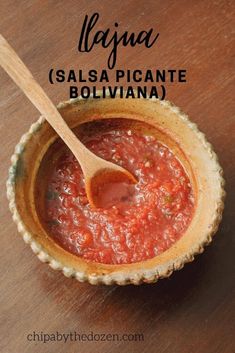 a bowl filled with salsa next to a spoon on top of a wooden table and text overlay says salsa salsa picantee bolivana