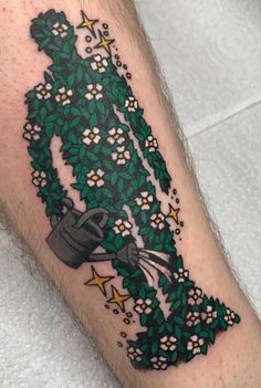 a man's leg with a green and white tattoo on it