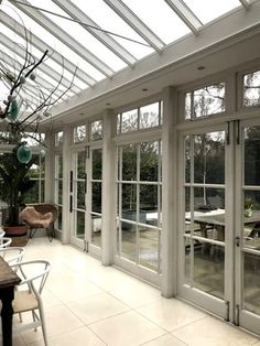 the inside of a house with glass walls and doors on either side of the room